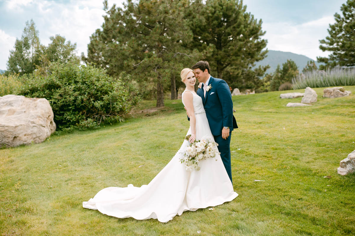 Bride and groom pose for wedding photos at Spruce Mountain Ranch.