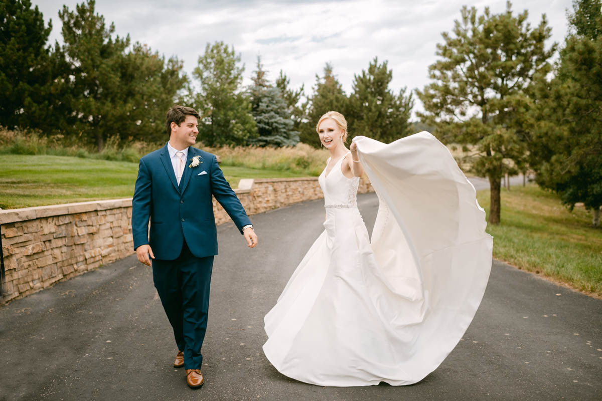 Bride and groom pose for wedding photos at Spruce Mountain Ranch.