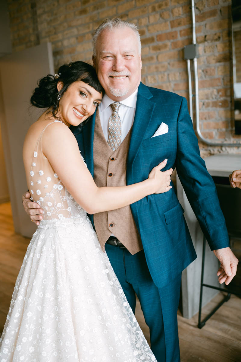 Bride hugging her dad.