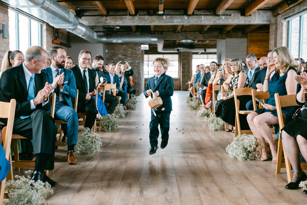 Cute ring bearer jumping down the aisle.