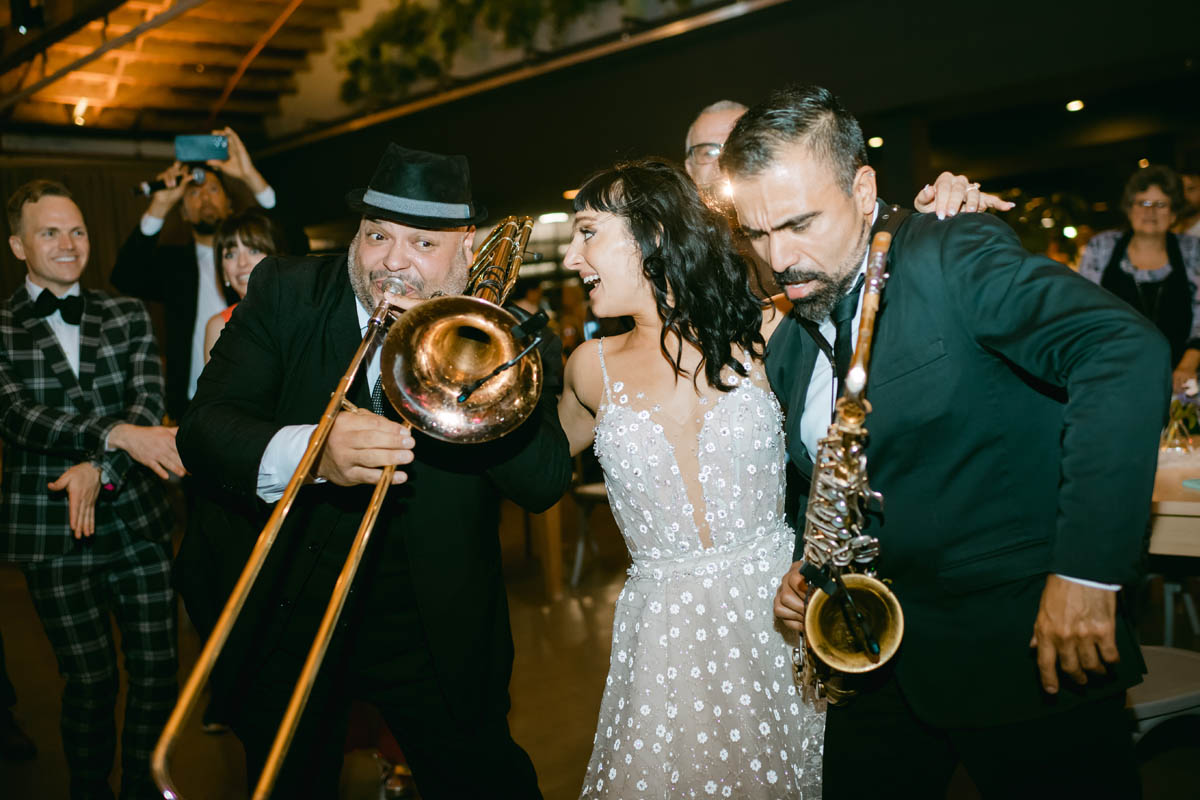 Bride dancing with musicians.