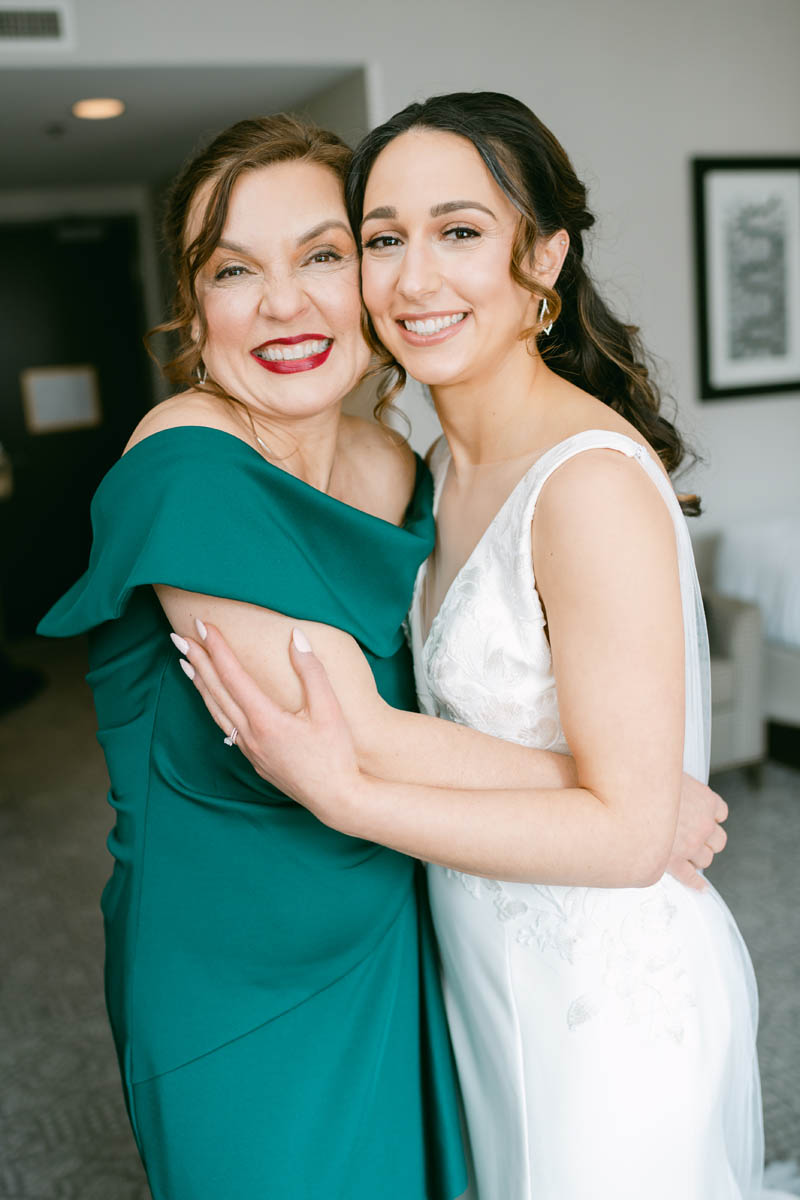 Bride and her mom hugging.