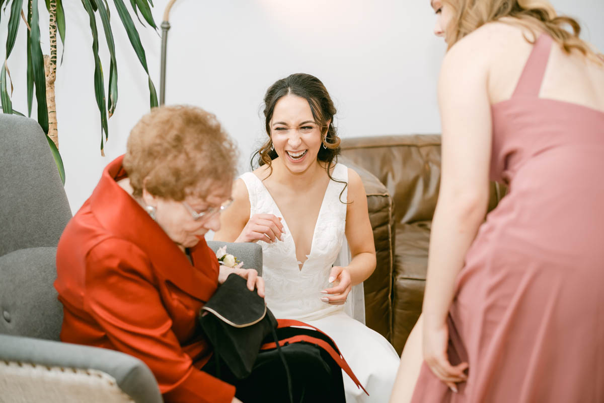 Bride laughing with her grandmother.