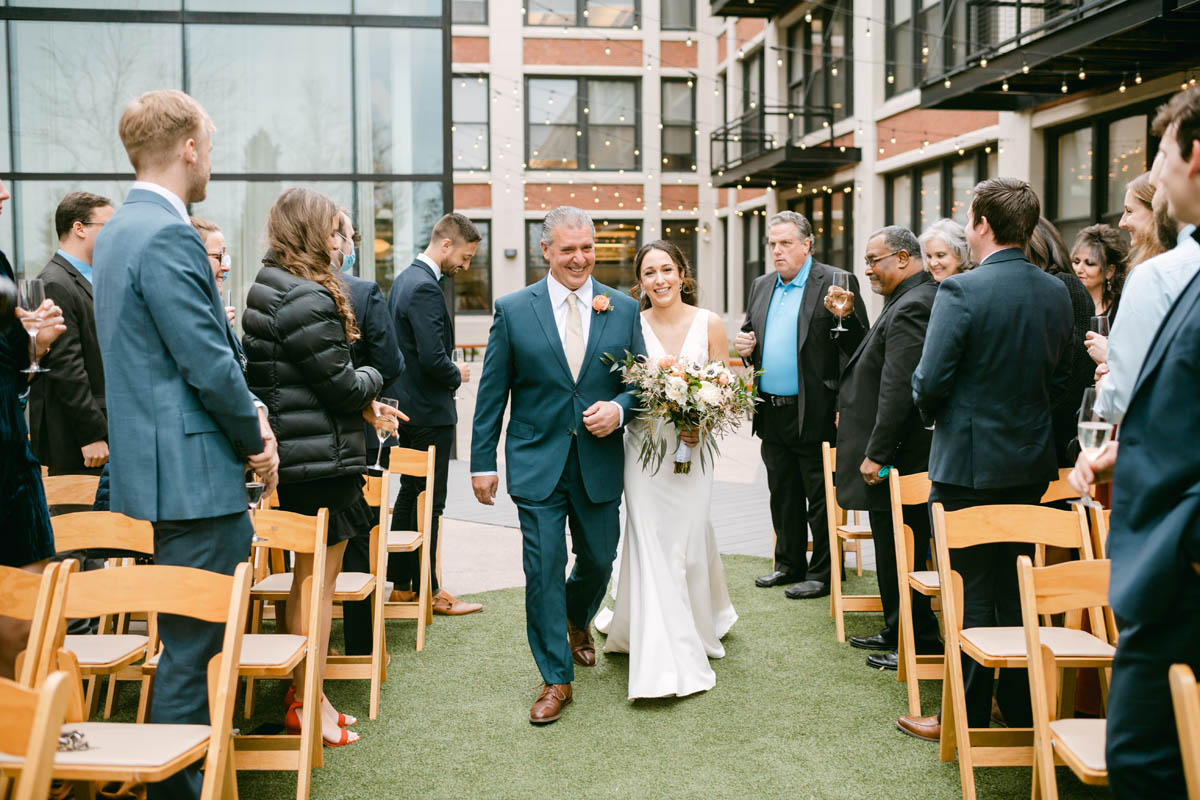 Greenhouse Loft Wedding bride walking down the aisle.