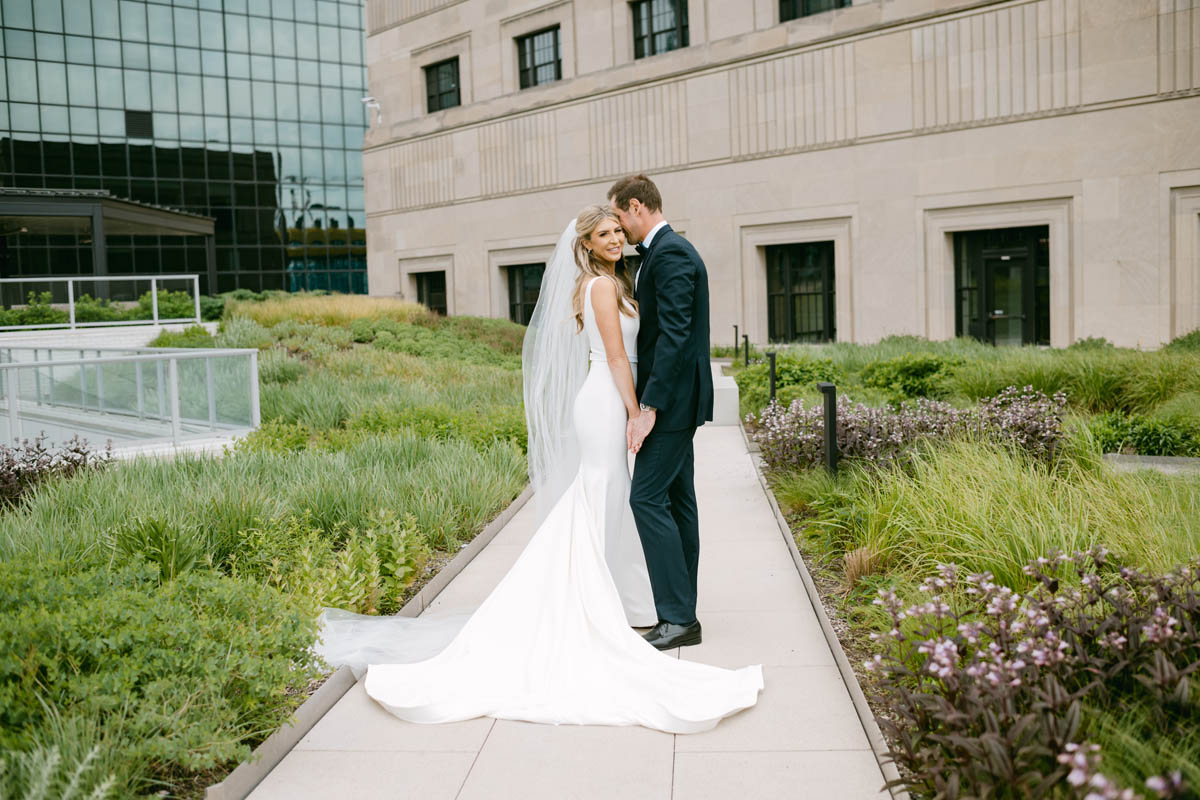 Bride and groom posing at Old Post Office wedding on the rooftop.