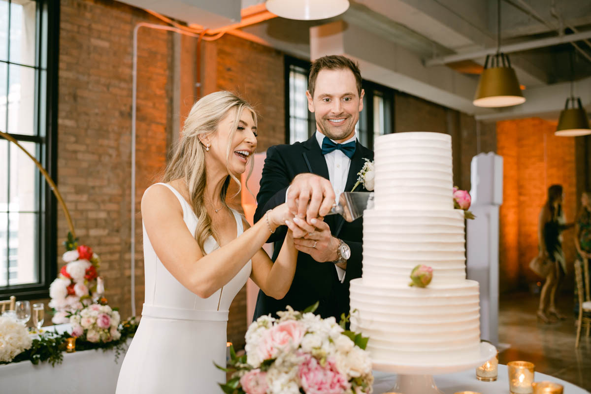 Couple cutting wedding cake at Old Post Office wedding reception.
