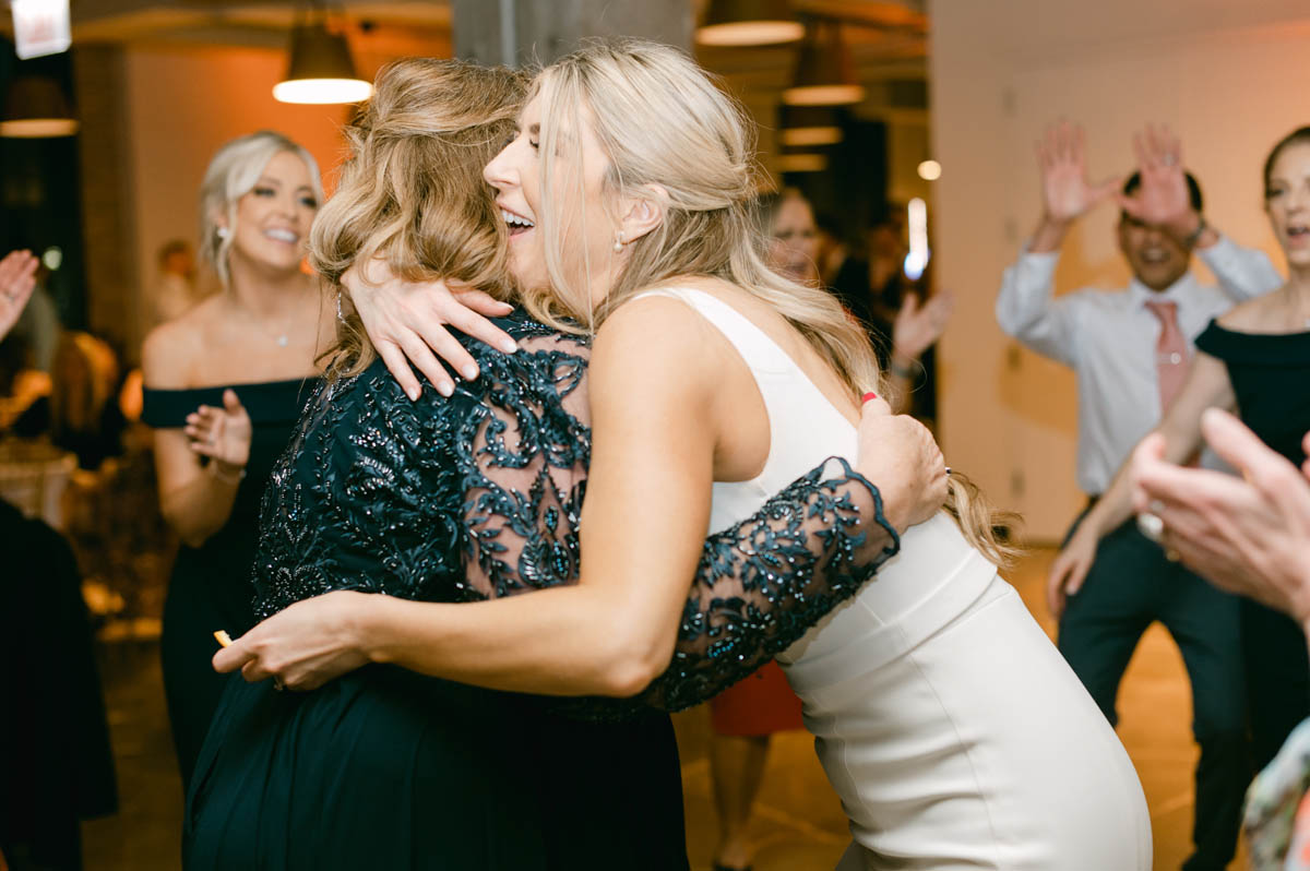 Bride hugging her mom.