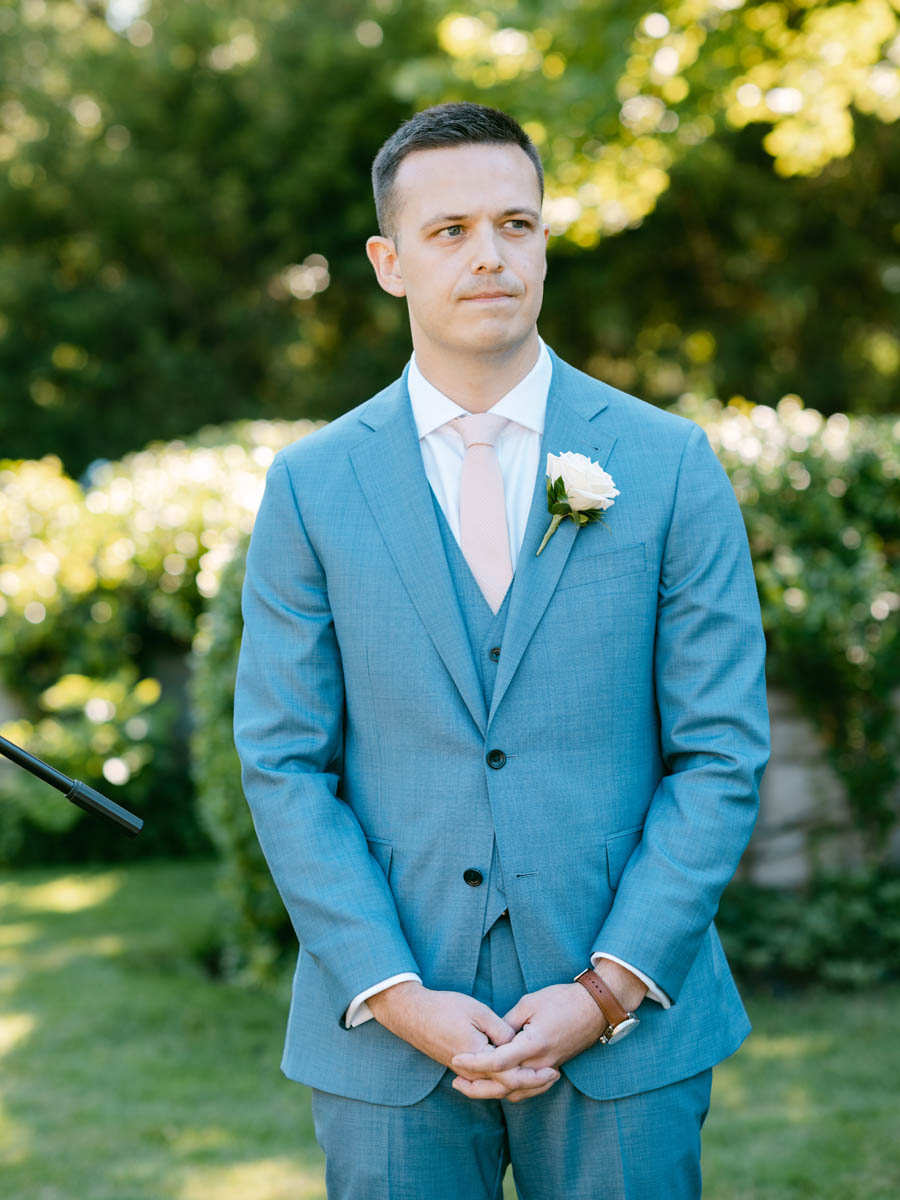 Groom watching bride walking down the aisle at Kenilworth Union Church wedding