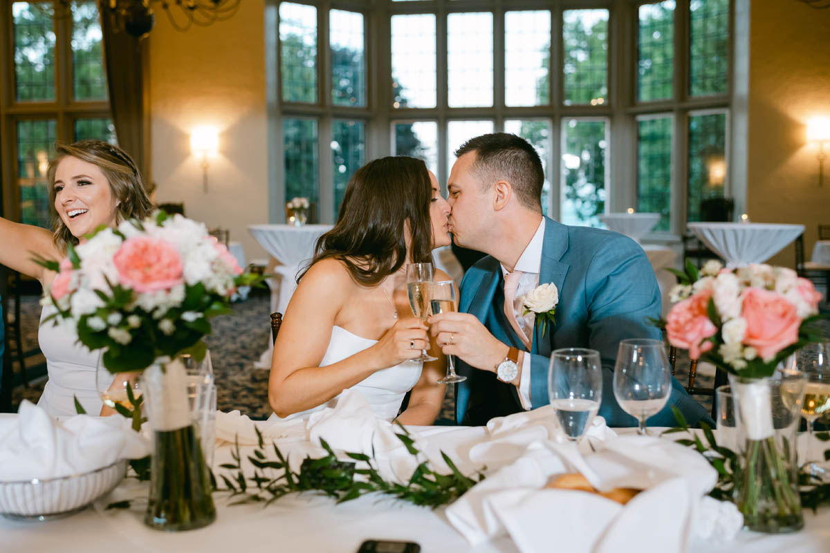 wedding couple kissing at Michigan Shores Club wedding reception