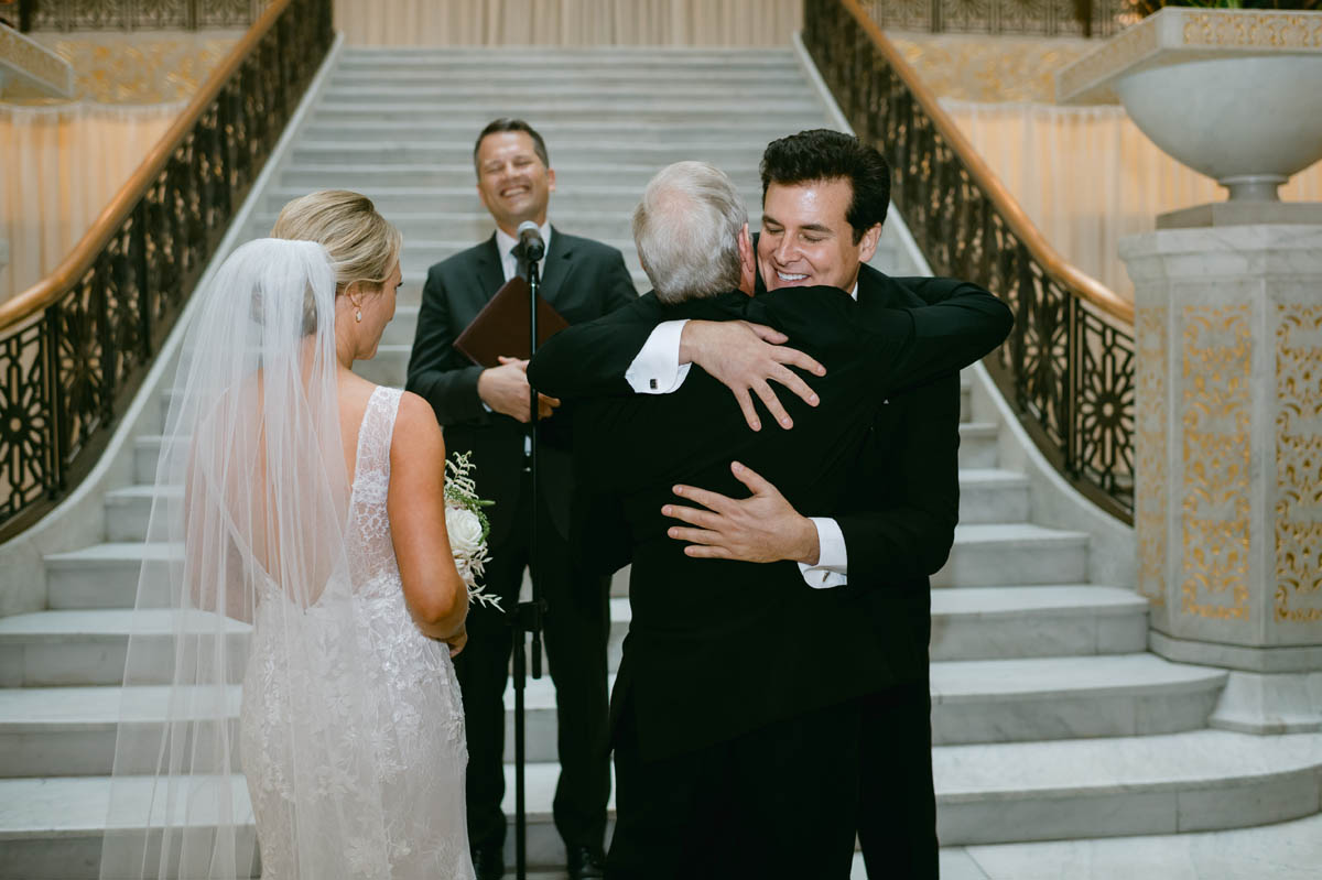 Groom hugging dad