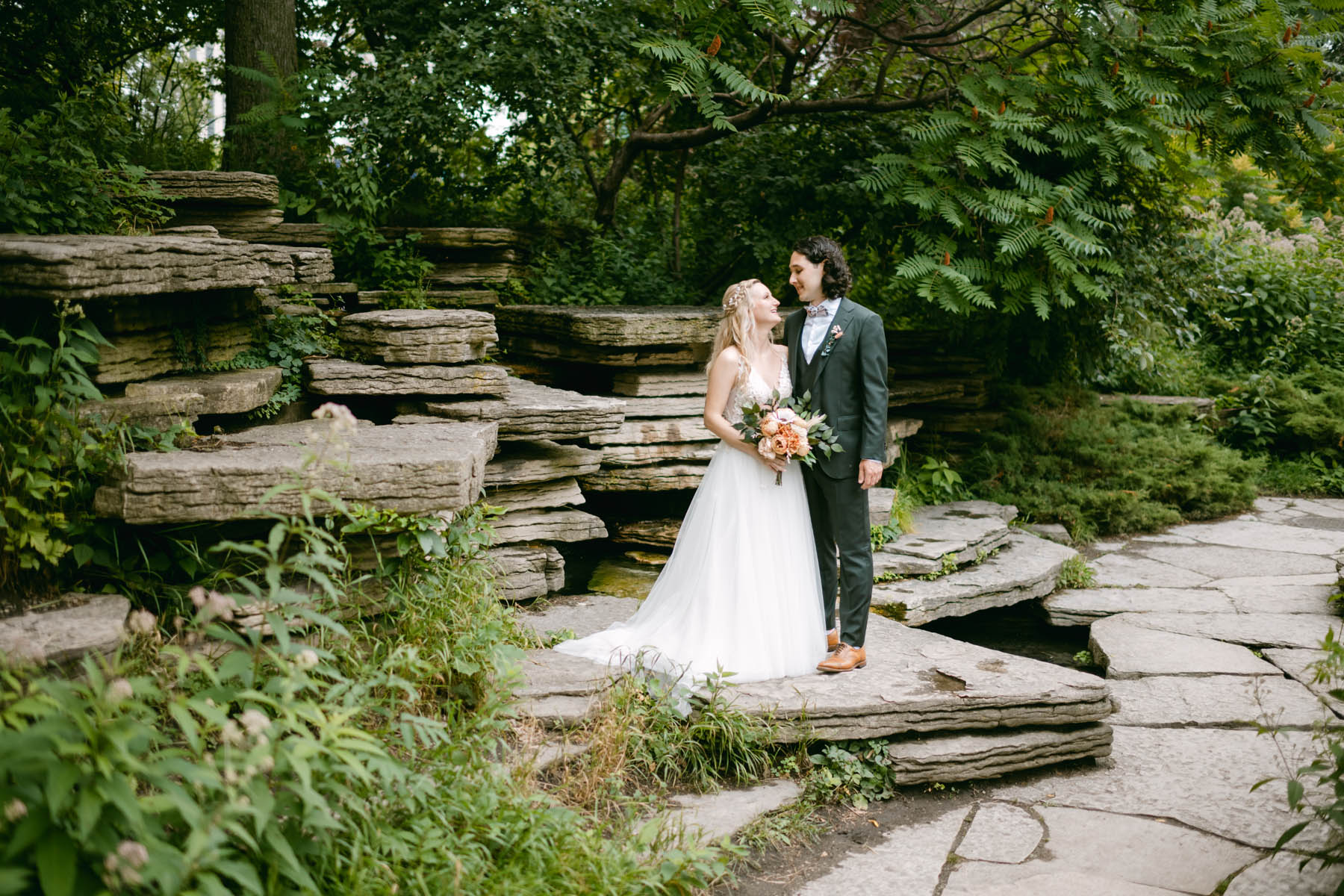 Bride and groom posing at lilly pond wedding