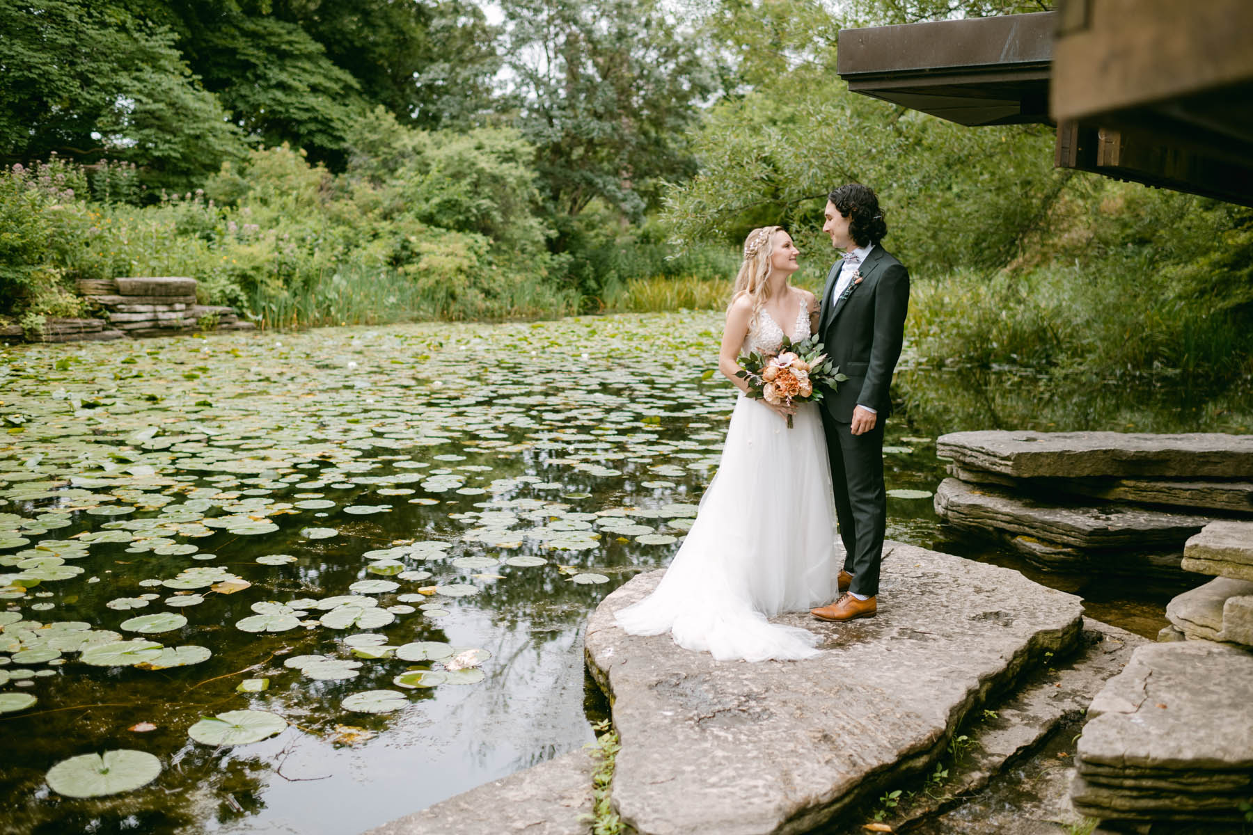 Bride and groom posing at lilly pond wedding