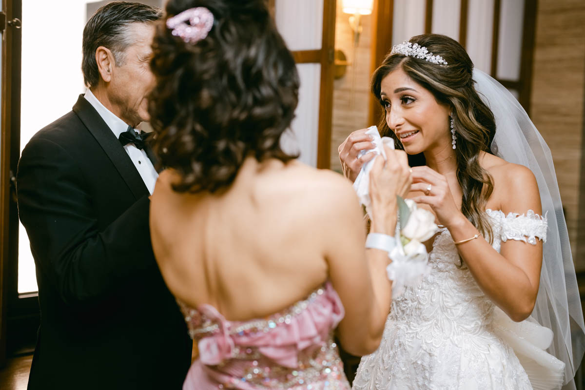 bride wiping tears on wedding day
