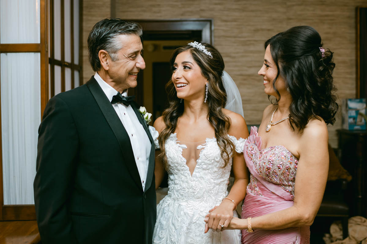 bride with her parents on wedding day