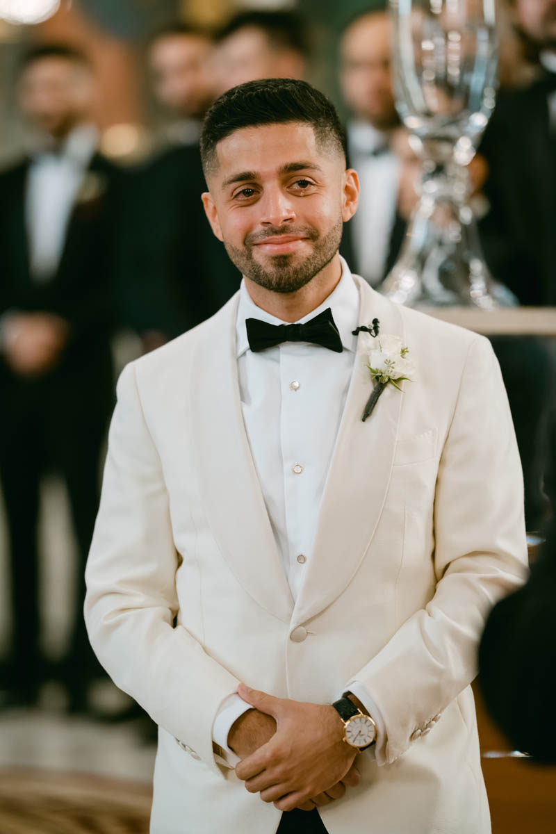 tearful groom seeing his bride walking down the aisle at annunciation cathedral greek church