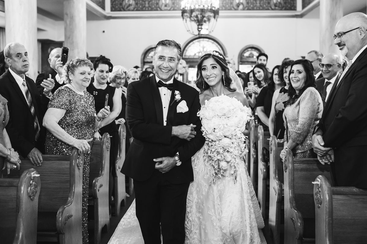 tearful bride walking down the aisle at the annunciation cathedral greek church