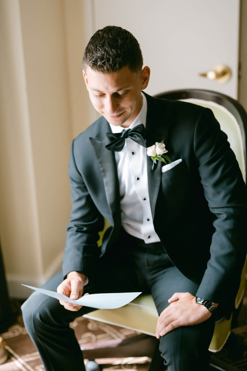 groom reading letter at Palmer House Hilton wedding
