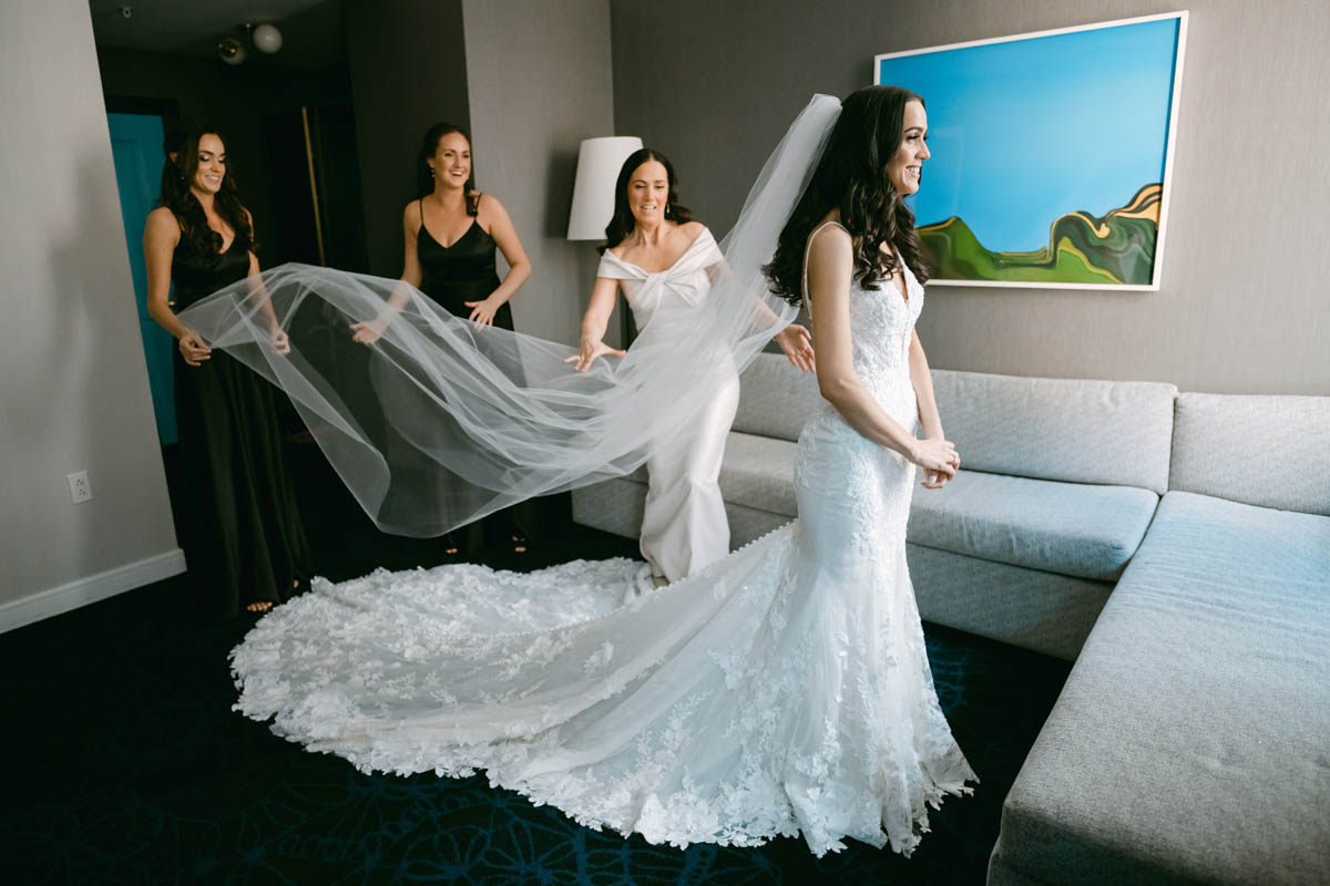 Mom and bridesmaids helping bride get ready
