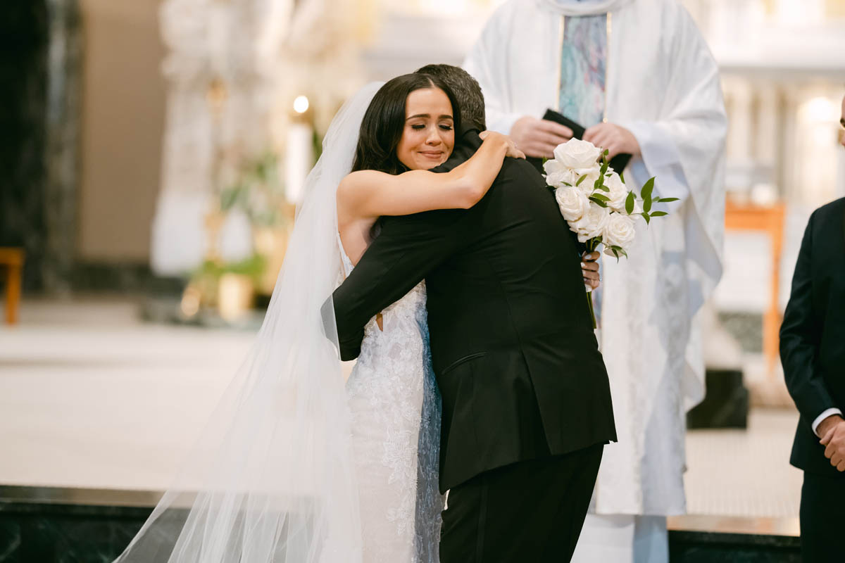 Bride hugging dad at DePaul wedding ceremony