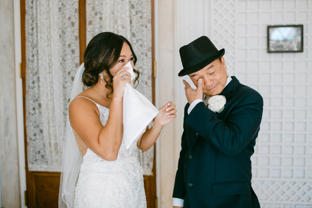 bride and dad tearing up