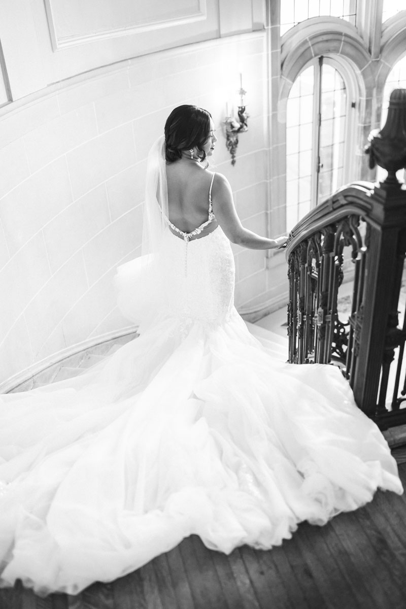 bride walking down stairs at armour house wedding light and airy