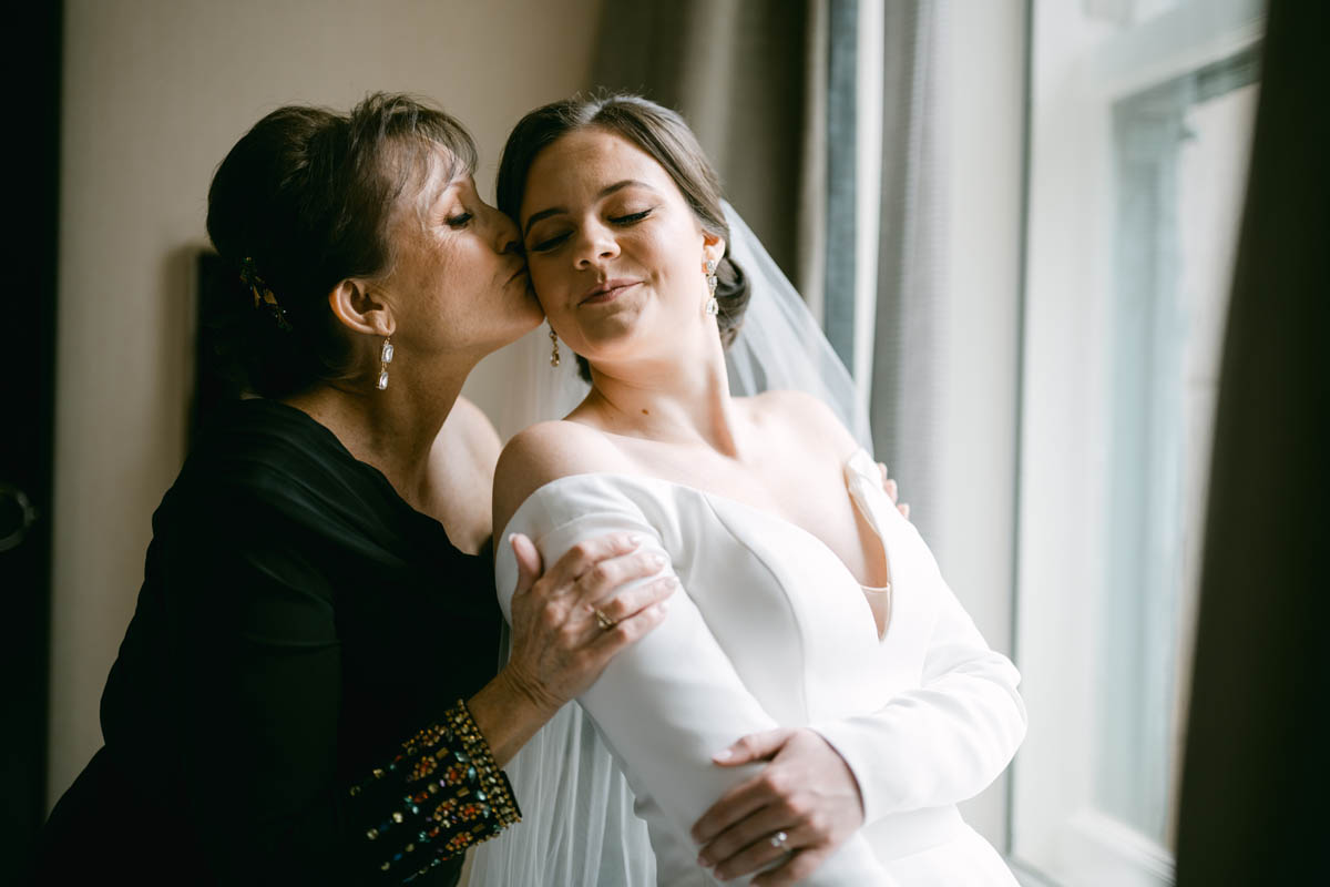 mom kissing bride at JW Marriott wedding