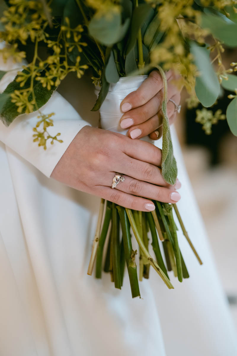 bride wearing irish claddagh ring