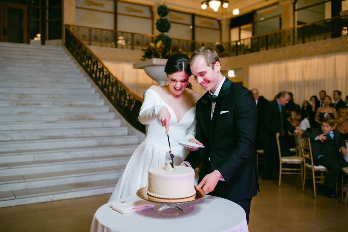 bride and groom cutting the cake