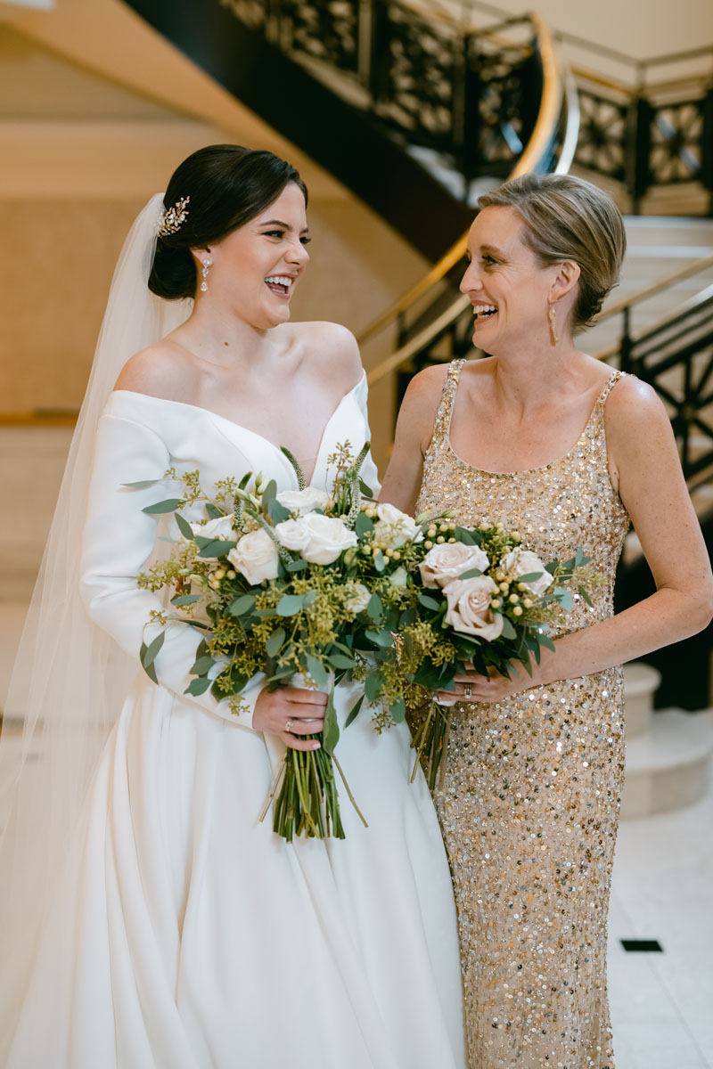 bride and sister laughing at JW Marriott wedding