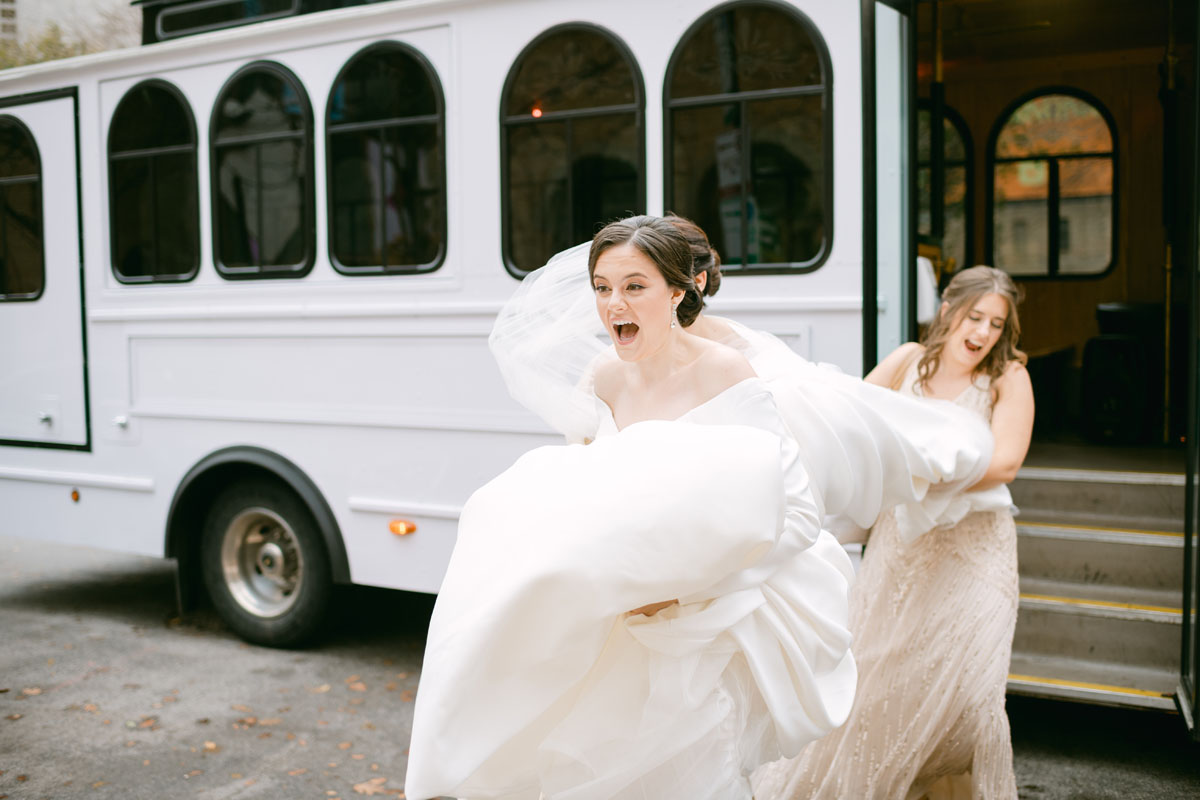 bride walking to church in the wind