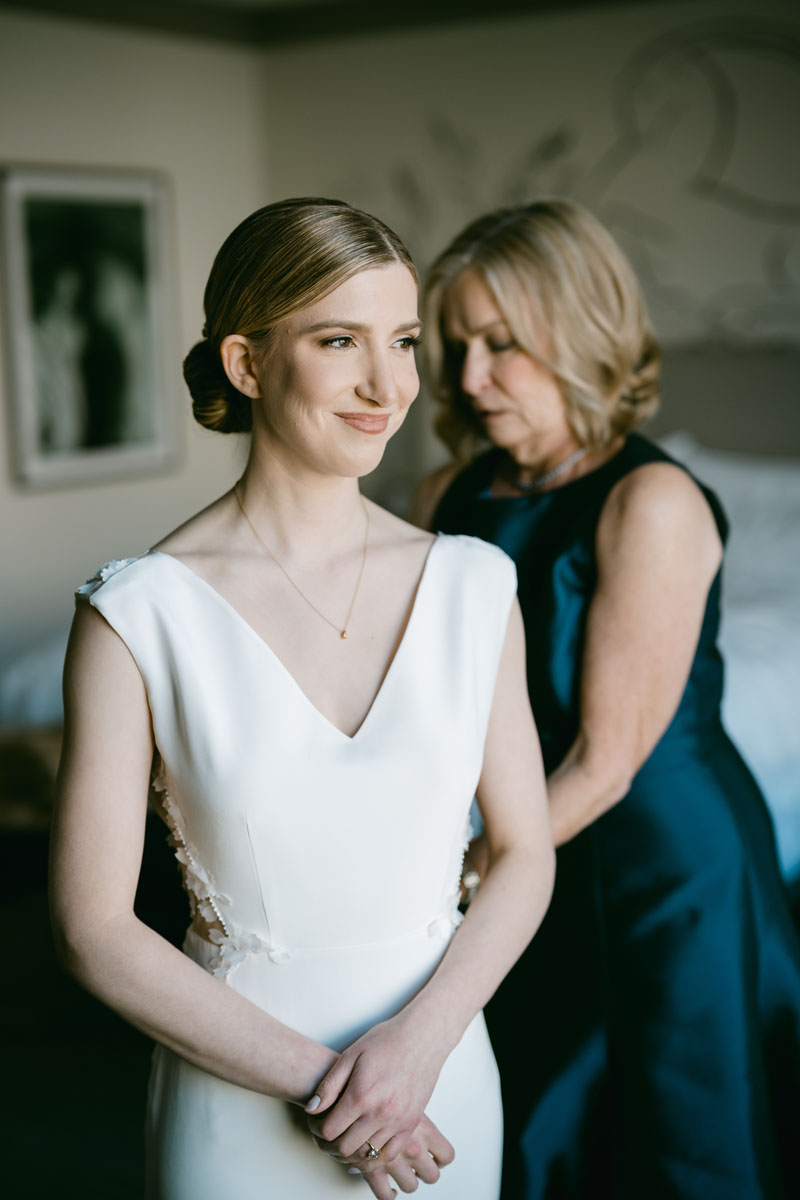 mom helping bride get ready