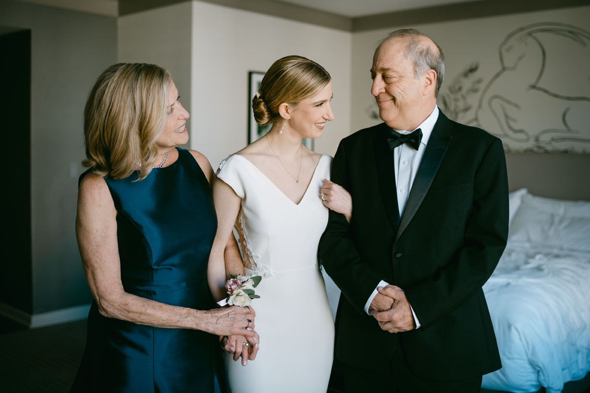 bride with parents at the Gwen wedding