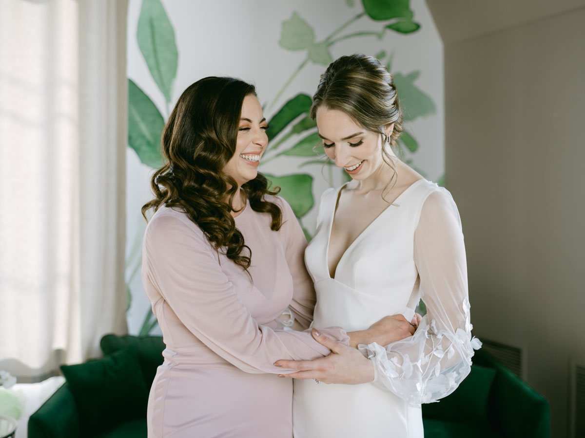 bride laughing with her sister
