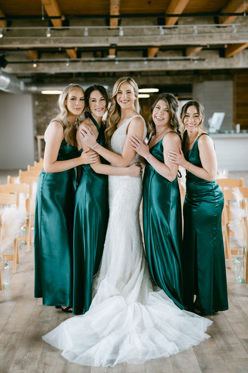 bridesmaids in emerald green winter wedding dresses