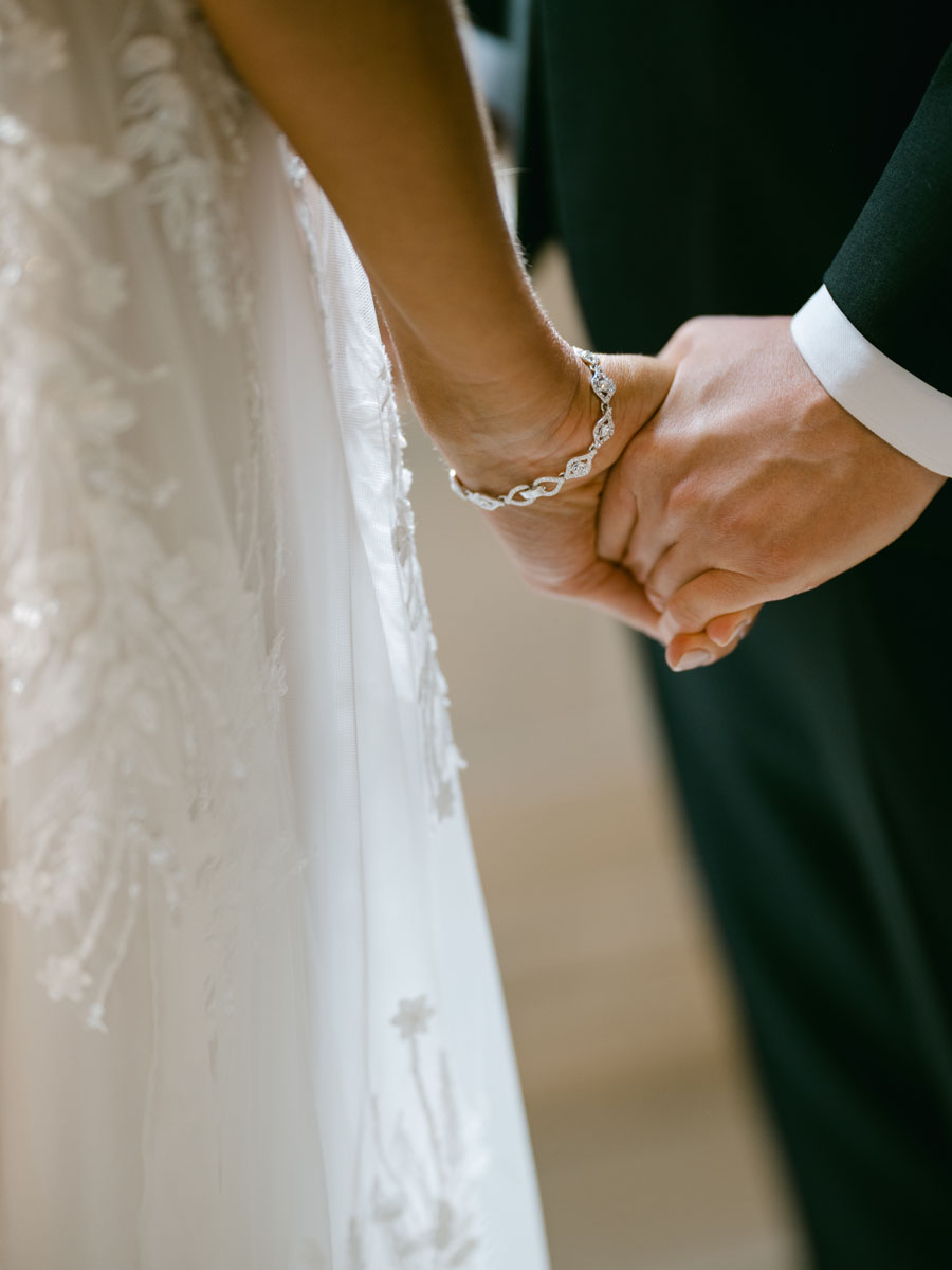 holding hands on wedding day