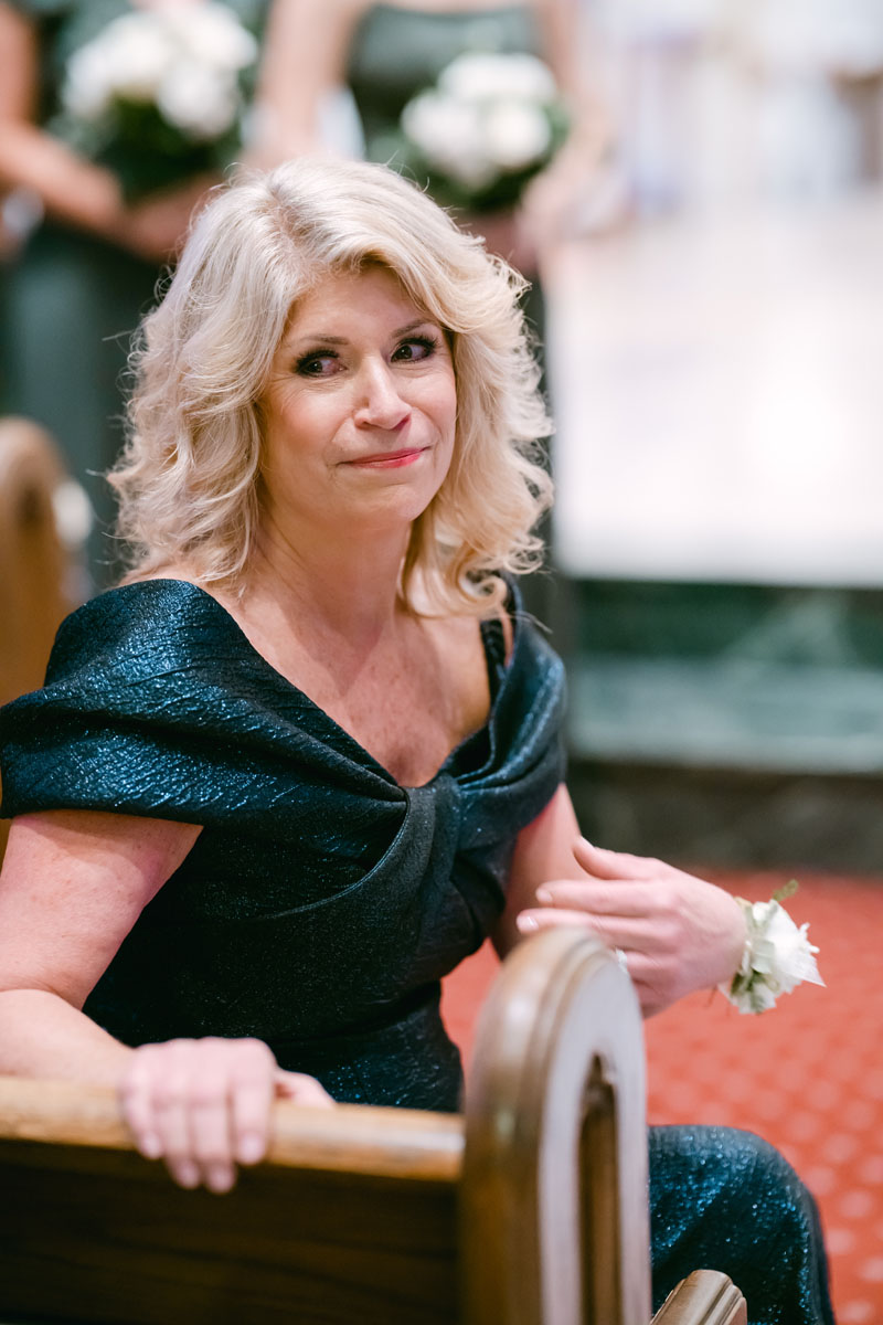 mom watching bride walking down the aisle