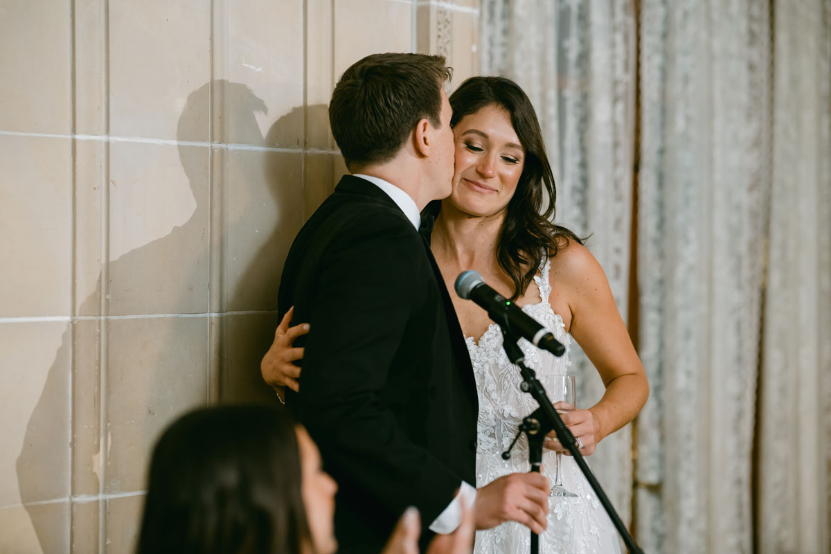 groom kissing bride at armour house wedding