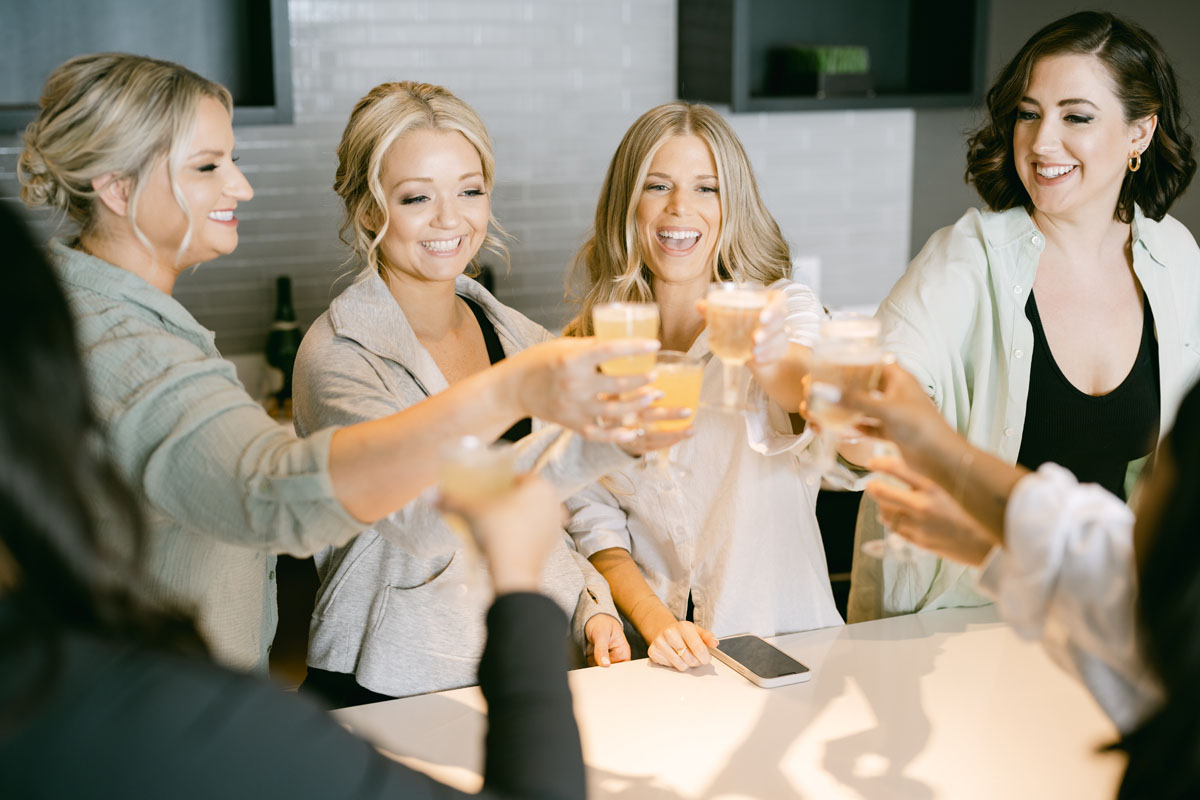 bridesmaids popping the champagne