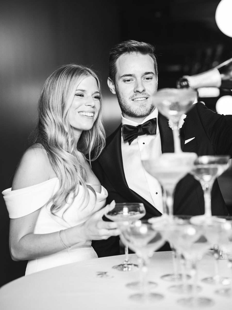 bride and groom pouring champagne tower