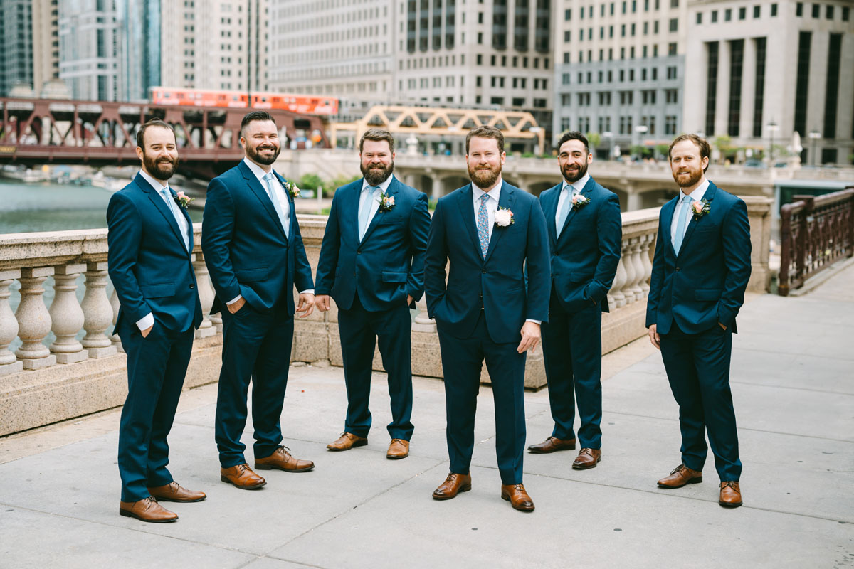 groomsmen in blue suits on the riverwalk