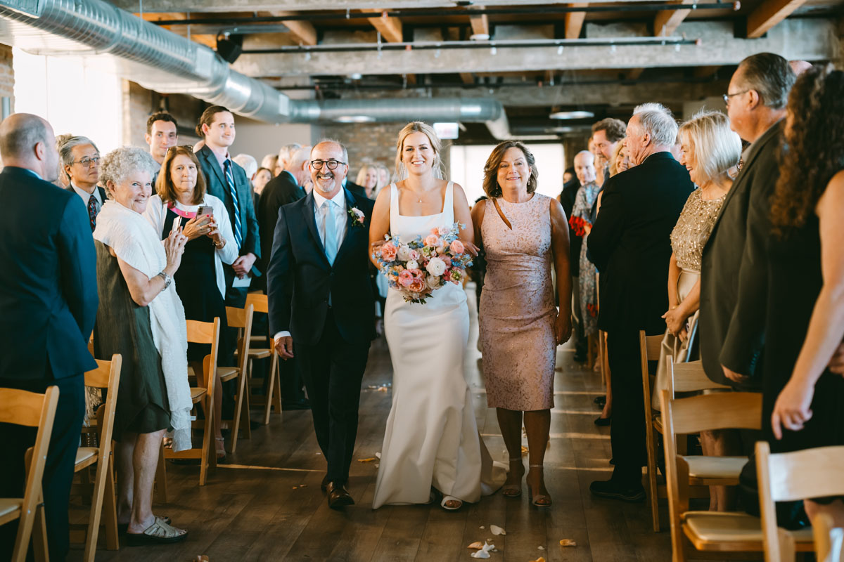 light and bright walden chicago wedding bride walking down the aisle