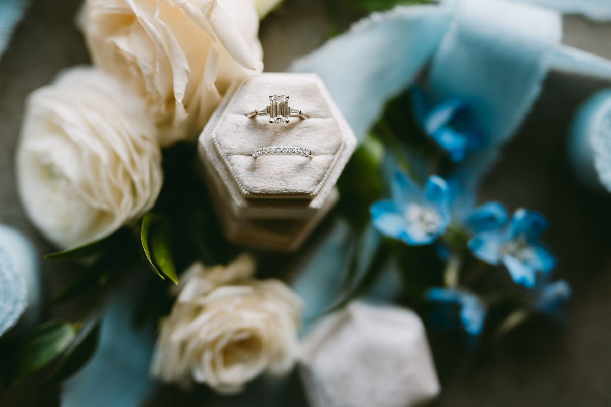 wedding ring detail shot with blue ribbon