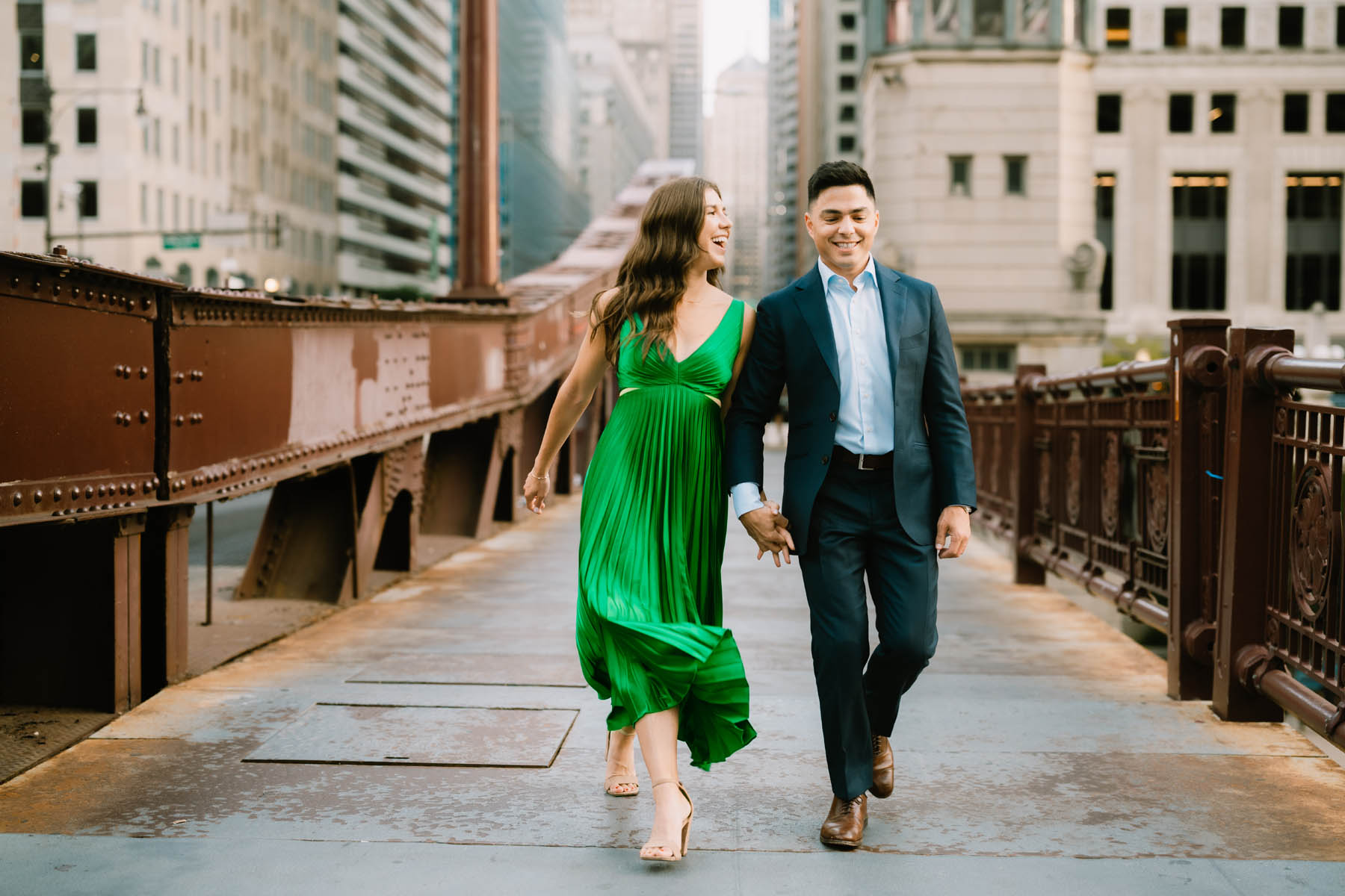 Engaged couple in emerald green dress by the Chicago riverwalk