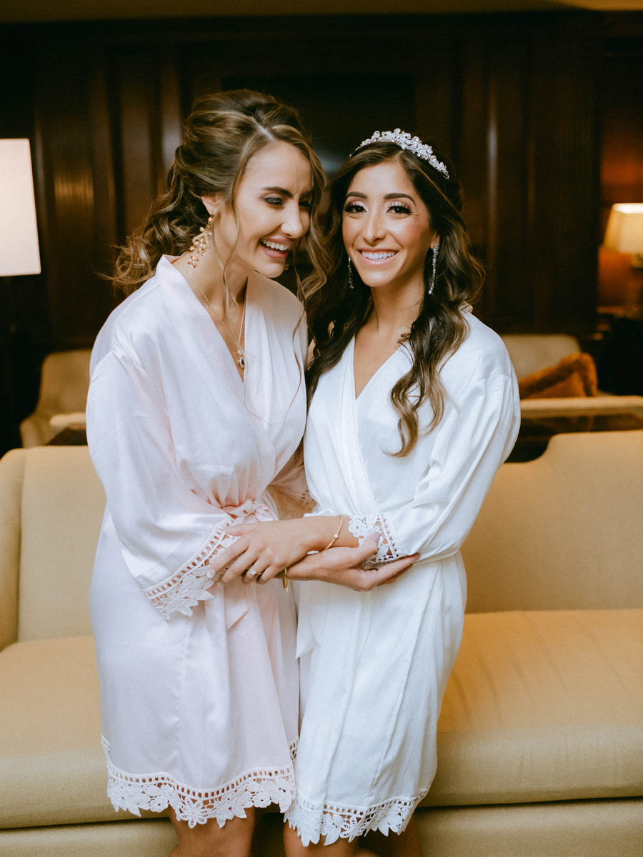 Bride and bridesmaid sharing a quiet moment before the wedding