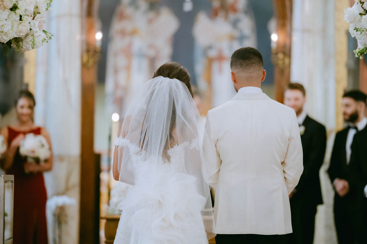 Bride and groom stand at the alter Annunciation Greek Orthodox Cathedral