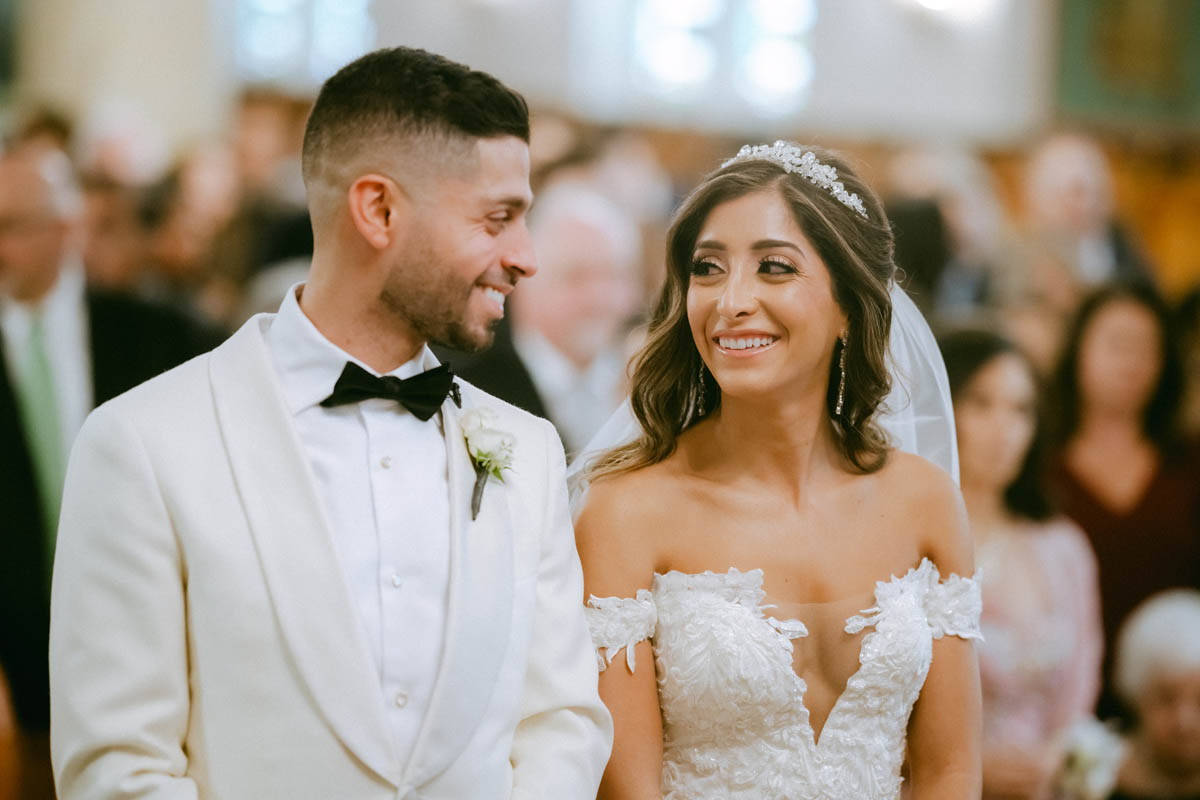 Bride and groom share a smile at Annunciation Greek Orthodox Cathedral