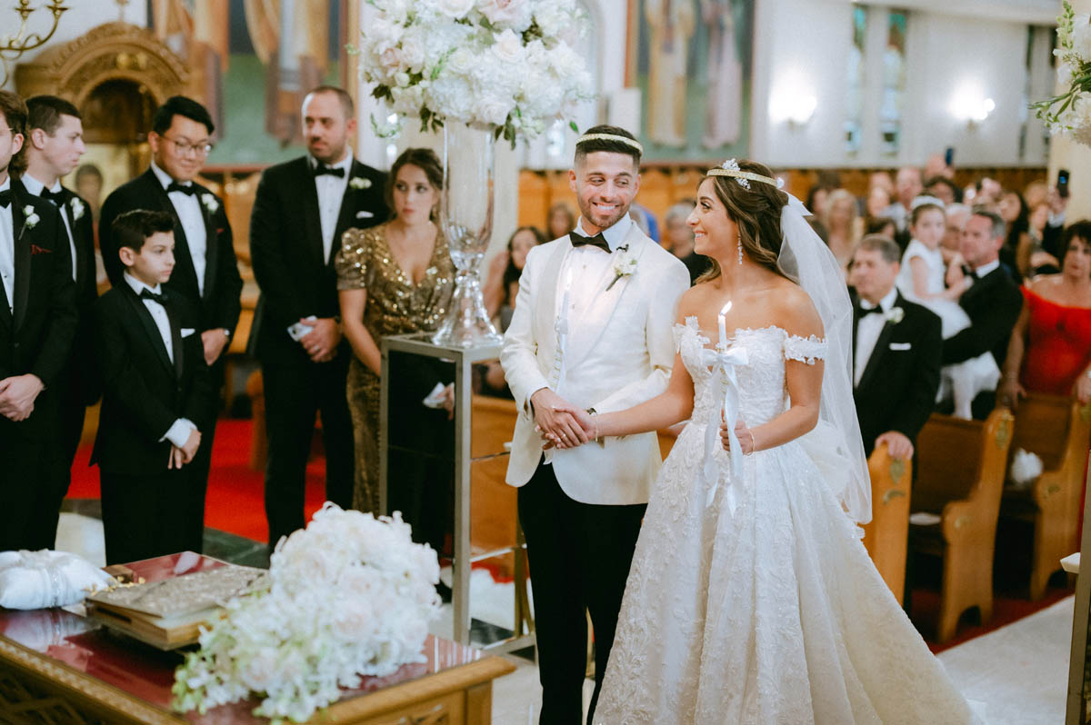 Bride and groom share a smile at Annunciation Greek Orthodox Cathedral