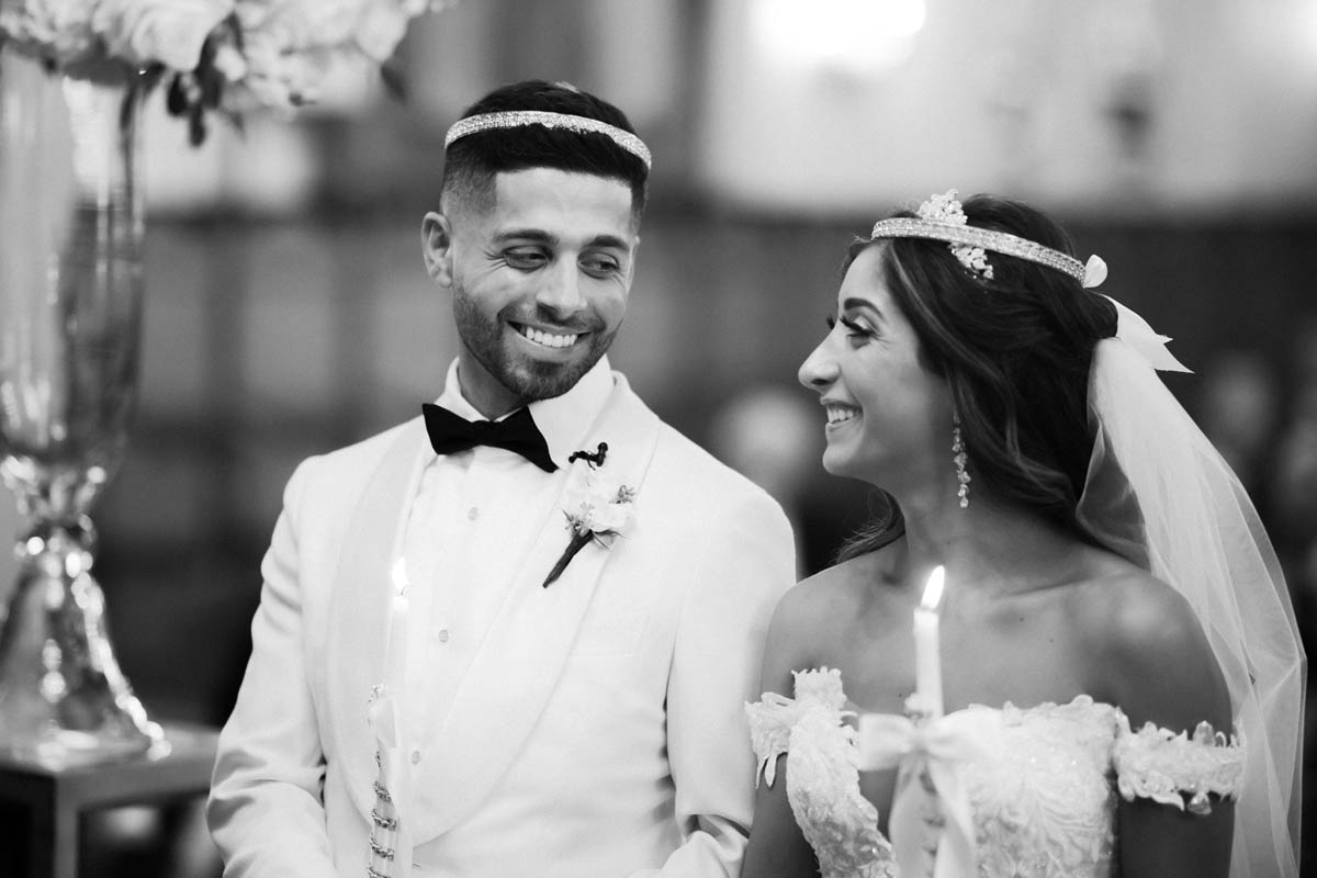 Bride and groom share a look at Annunciation Greek Orthodox Cathedral