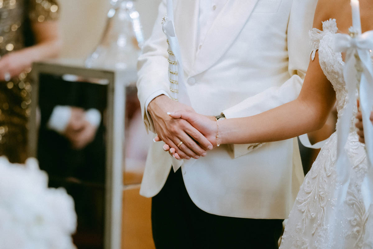 Greek wedding ceremony couple holds hands at Annunciation Greek Orthodox Cathedral