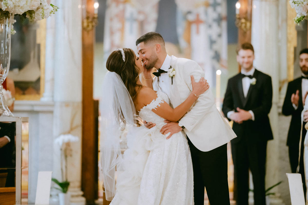 Bride and groom first kiss at Annunciation Greek Orthodox Cathedral